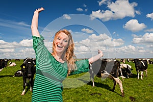 Dutch girl happy in field with cows photo