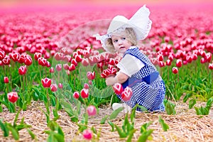 Dutch girl in tulip field in Holland