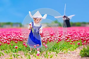 Dutch girl in tulip field in Holland