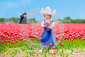 Dutch girl in tulip field in Holland