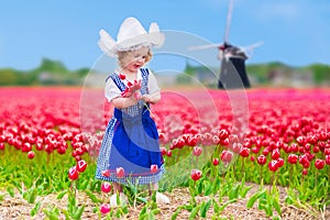 Dutch girl in tulip field in Holland