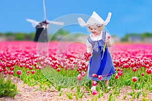 Dutch girl in tulip field in Holland