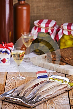 Dutch herring with onions and pickles on rustic table