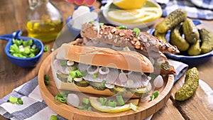 Dutch herring. Toast with Dutch herring, onions, pickles. Traditional rustic appetizer with seafood. Popular food in the