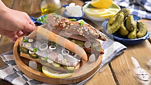 Dutch herring. Toast with Dutch herring, onions, pickles. Traditional rustic appetizer with seafood. Popular food in the