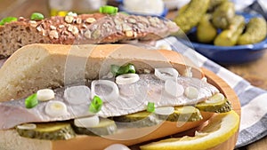 Dutch herring. Toast with Dutch herring, onions, pickles. Traditional rustic appetizer with seafood. Popular food in the