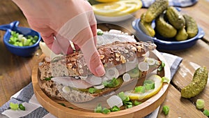 Dutch herring. Toast with Dutch herring, onions, pickles. Traditional rustic appetizer with seafood. Popular food in the