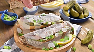 Dutch herring. Toast with Dutch herring, onions, pickles. Traditional rustic appetizer with seafood. Popular food in the