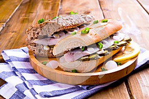 Dutch herring. Toast with Dutch herring, onions, pickles. Traditional rustic appetizer with seafood. Popular food in the