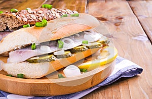 Dutch herring. Toast with Dutch herring, onions, pickles. Traditional rustic appetizer with seafood. Street food in the