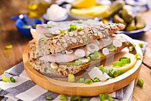 Dutch herring. Toast with Dutch herring, onions, pickles. Traditional rustic appetizer with seafood. Street food in the