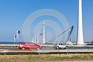 Dutch highway with cars along construction site wind turbines