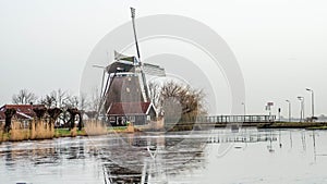 Dutch historic water mill on gray winter morning