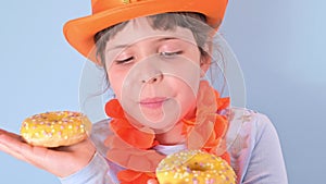 Dutch holiday King Day. Traditional festival on April 27 in the Netherlands. A little girl in a festive orange hat on a