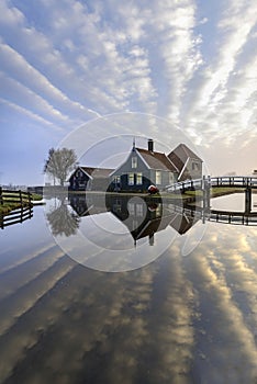 Dutch house mirrored on the calm canal