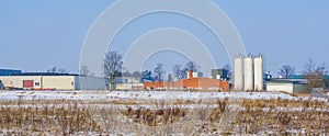 Dutch industry landscape with a warehouse and some white tanks, Majoppeveld a industrial terrain in the city of Roosendaal, The