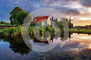 Dutch landscape with windmill at dramatic sunset, Zaandam, Amsterdam, Netherlands photo