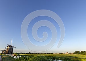 Dutch landscape with windmills and free space for your message