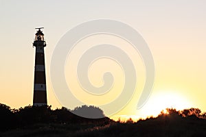 Dutch lighthouse Bornrif in Ameland dunes at sunset