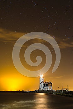 Dutch Lighthouse `Horse of Marken` under the starry night sky