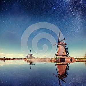 Dutch mill at night. Starry sky. Holland Netherlands.