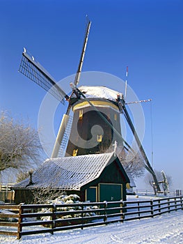 A Dutch mill in a winter landscape