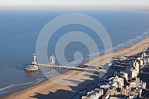 Dutch pier Scheveningen with long shadows Kurhaus at the beach