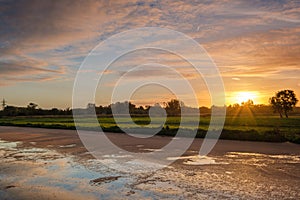 Dutch polder landscape with reflection of a multi coloured sunrise sky