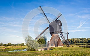 Dutch polder mill against a blue sky