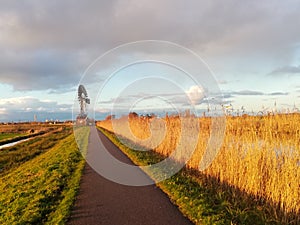 Dutch polder windmill on dike for drainage