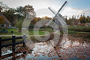 Dutch polder windmill with reflection in the water