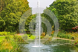 Dutch public park with a pond with working fountain