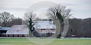 Dutch rural winter landscape with farm house.