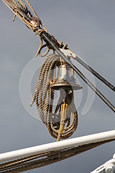 Dutch sailing ship Morgenster. Ship`s bell on a vertical rigging close-up photo