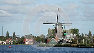 Dutch Windmill De Bonte Hen on the Zaan river at the Zaanse Schans in Zaandam, the Netherlands photo