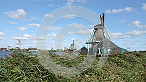 Dutch Windmills on the Zaan river at the Zaanse Schans in Zaandam, the Netherlands photo
