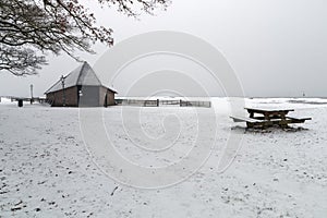 A dutch sheap house in the snow.