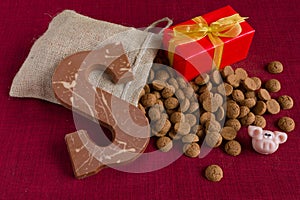 Dutch Sinterklaas tradition: A chocolate letter, a present and a bag with candy called Pepernoten