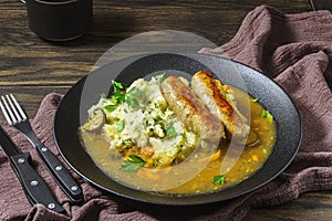 Dutch stamppot of potatoes, kale and sausages on plate