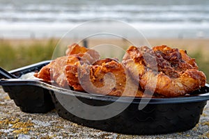 Dutch street seafood, deep fried cod fish fillet with garlic sauce called in Netherlands kibbeling and North sea beach on