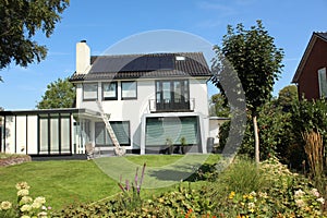 dutch street village architecture house bush places neighbourhood facade white solar panel windows doors brown roof estate