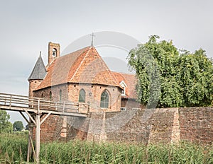Dutch 13th century castle with trees and church chapel photo