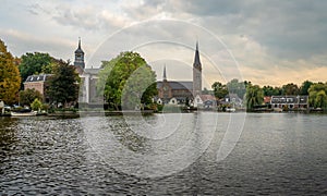 Dutch town Ouderkerk aan de Amstel, view of the church on the bank of river Amstel