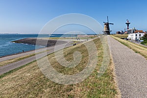 Dutch traditional windmill at dike near city Vlissingen