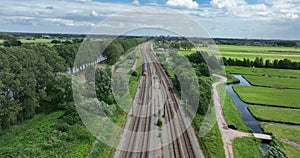 Dutch train in green open grassland landscape. Green alternative sustainable transportation method. Commute traffic