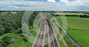 Dutch train in green open grassland landscape. Green alternative sustainable transportation method. Commute traffic