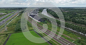 Dutch train passing commuting traveling in forrest grassland nature landscape. Sustainable travel technology by rail