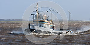 Dutch tugboat sailing with high waves