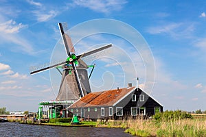 Dutch typical landscape. Traditional old dutch windmill with house blue sky in the Zaanse Schans village, Netherlands. Famous tour