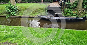 Dutch village with colorful ornamental garden and spring flowers, Giethoorn